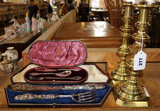 Pair of brass candlesticks and 2 cased sets of plated Sevres